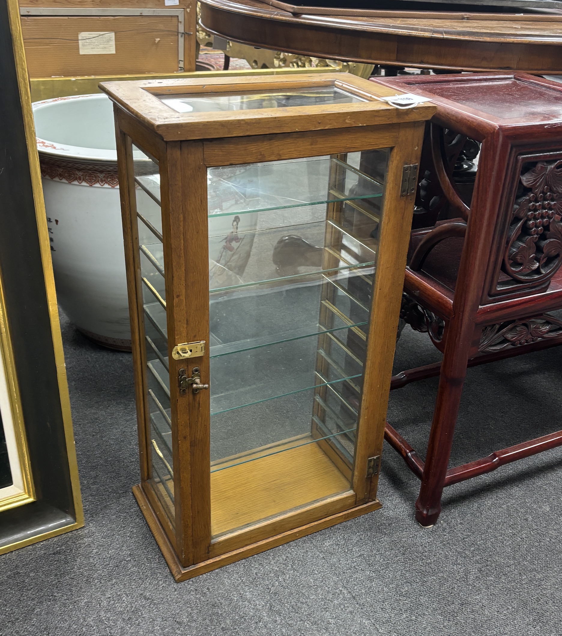 A late 19th/early 20th century glazed oak shop display case, width 37cm, depth 22cm, height 68cm